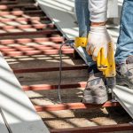 Close up of worker applying fasteners to secure composite decking